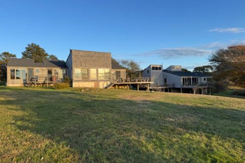 modern home with large windows and wooden deck