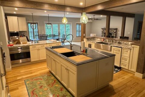 Open kitchen with island and wood floors.