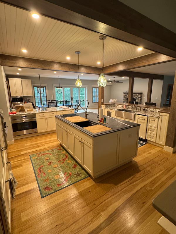 Open kitchen with island and wood floors.