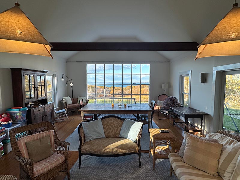 open-concept kitchen and dining area with wooden floors and beams