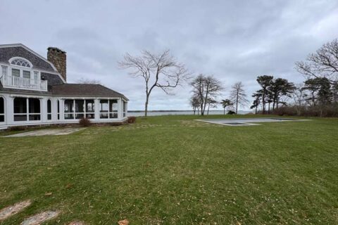 Large lawn beside a coastal house with ocean view