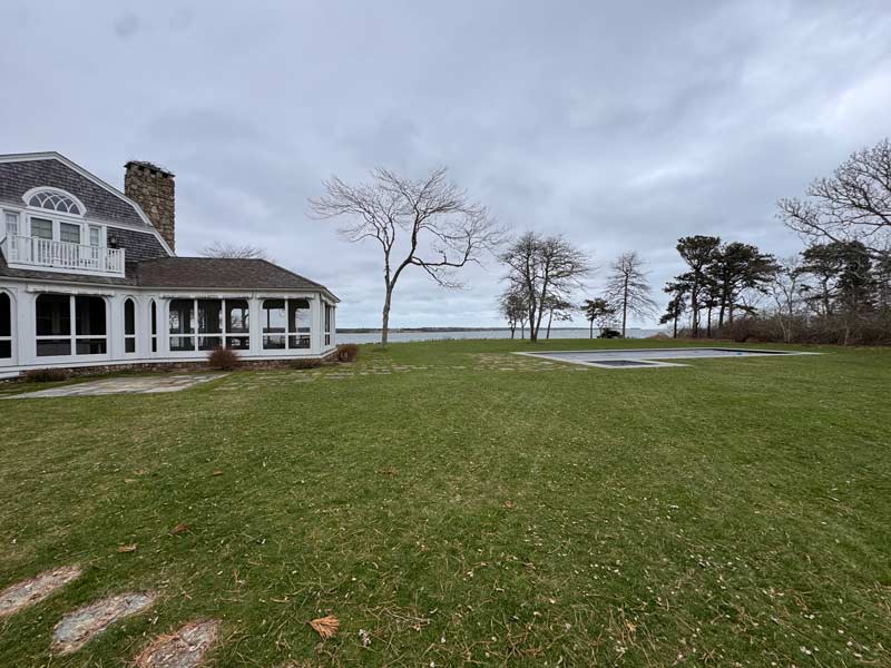 Large lawn beside a coastal house with ocean view