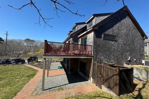 Wood house exterior with raised deck and yard