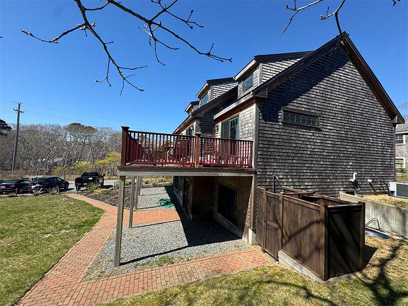 Wood house exterior with raised deck and yard