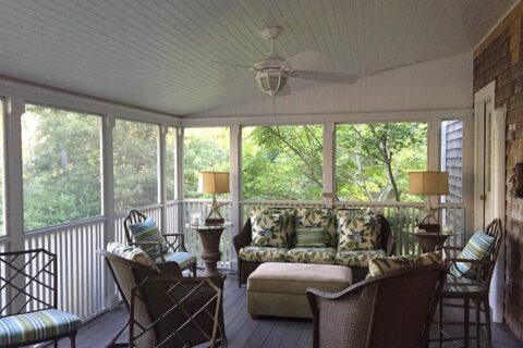 Screened porch with wicker furniture