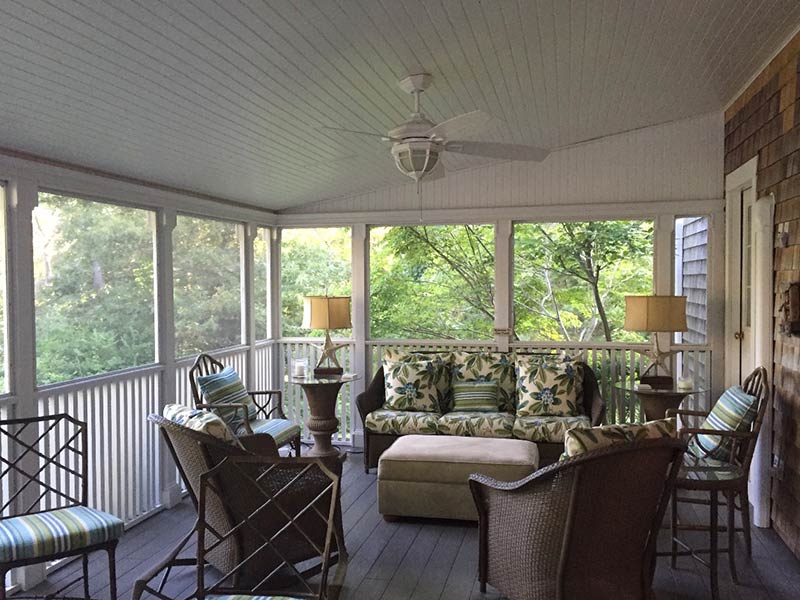 Screened porch with wicker furniture Screened porch with wicker furniture