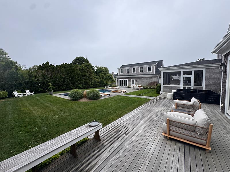 An outdoor deck with a pool and various lawn furniture An outdoor deck with a pool and various lawn furniture