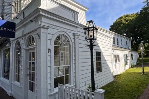 Historic white colonial-style building with arched windows
