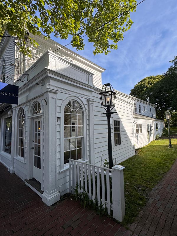 Historic white colonial-style building with arched windows Historic white colonial-style building with arched windows