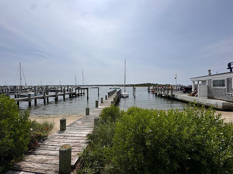serene dock with several boats moored at the end serene dock with several boats moored at the end